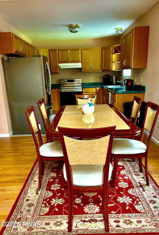 129 Skyview Rd, Dingmans Ferry, PA 18328 - kitchen with stainless steel appliances, open shelves, light wood finished floors, under cabinet range hood, and brown cabinets