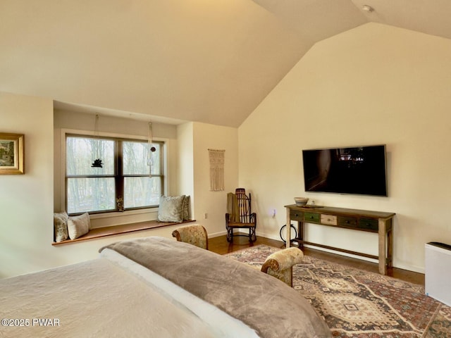 bedroom with baseboards and vaulted ceiling