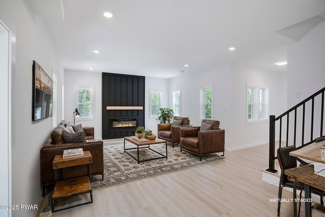131 Song Mountain Dr, Tafton, PA 18464 - living room featuring healthy amount of natural light, stairs, light wood-style flooring, a large fireplace, and recessed lighting