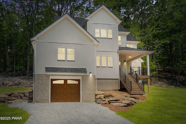 131 Song Mountain Dr, Tafton, PA 18464 - view of front of property with roof with shingles, a garage, stairs, and gravel driveway