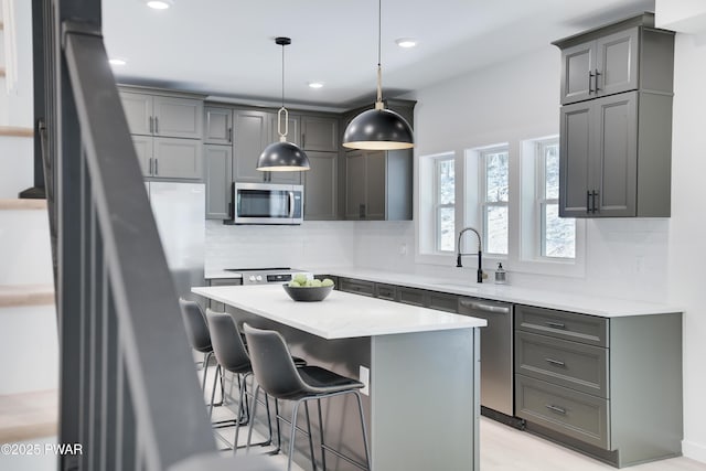 131 Song Mountain Dr, Tafton, PA 18464 - kitchen with appliances with stainless steel finishes, backsplash, a kitchen breakfast bar, gray cabinetry, and recessed lighting