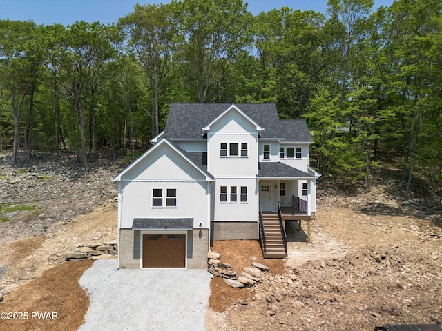 131 Song Mountain Dr, Tafton, PA 18464 - view of front of house featuring roof with shingles, an attached garage, covered porch, driveway, and stairs