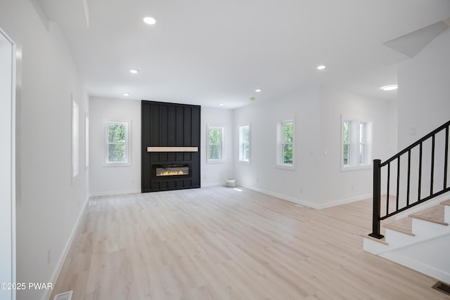 131 Song Mountain Dr, Tafton, PA 18464 - unfurnished living room featuring healthy amount of natural light, light wood finished floors, stairs, and recessed lighting