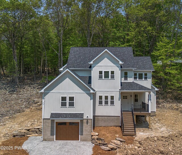 131 Song Mountain Dr, Tafton, PA 18464 - view of front facade with roof with shingles, an attached garage, stairs, covered porch, and driveway