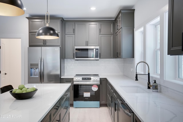 131 Song Mountain Dr, Tafton, PA 18464 - kitchen with stainless steel appliances, gray cabinetry, light stone countertops, backsplash, and recessed lighting