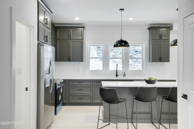 131 Song Mountain Dr, Tafton, PA 18464 - kitchen with stainless steel appliances, light countertops, tasteful backsplash, gray cabinetry, and recessed lighting