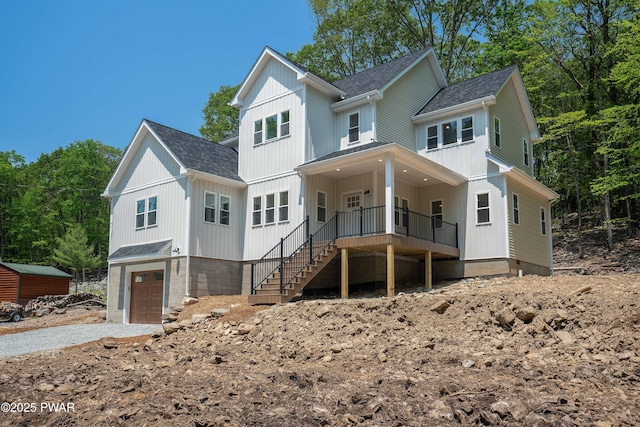 131 Song Mountain Dr, Tafton, PA 18464 - view of front of house featuring roof with shingles, driveway, a porch, an attached garage, and stairs