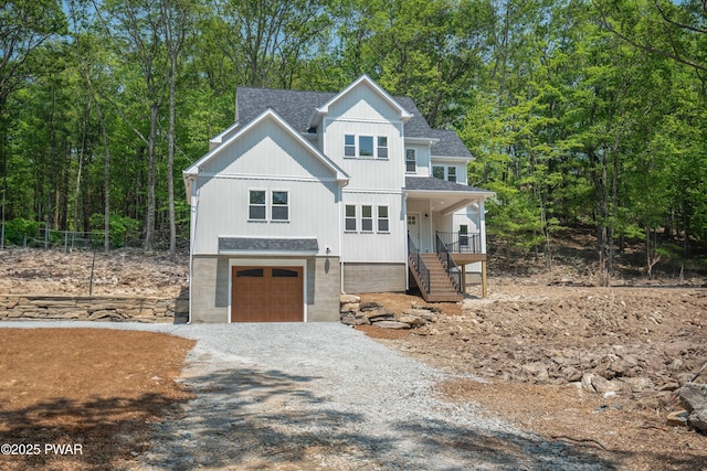 131 Song Mountain Dr, Tafton, PA 18464 - view of front facade with a garage, a shingled roof, stairway, and gravel driveway