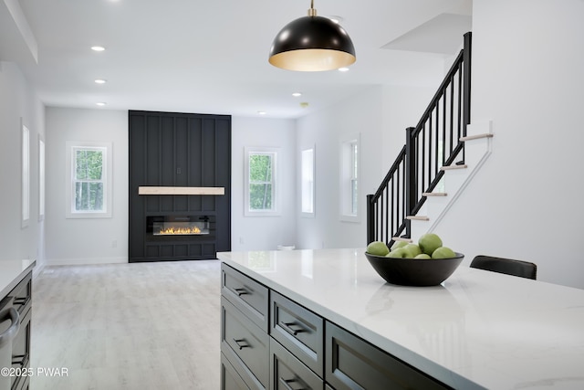 131 Song Mountain Dr, Tafton, PA 18464 - kitchen featuring plenty of natural light, light wood-style floors, light stone counters, decorative light fixtures, and recessed lighting