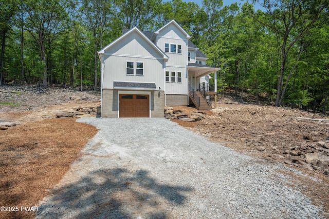 131 Song Mountain Dr, Tafton, PA 18464 - view of front of house featuring an attached garage, driveway, covered porch, and stairs