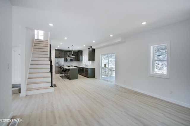 131 Song Mountain Dr, Tafton, PA 18464 - unfurnished living room featuring light wood-style floors, recessed lighting, and stairs