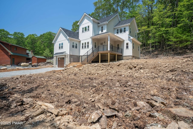 131 Song Mountain Dr, Tafton, PA 18464 - view of front of home featuring roof with shingles, stairs, an attached garage, a porch, and board and batten siding