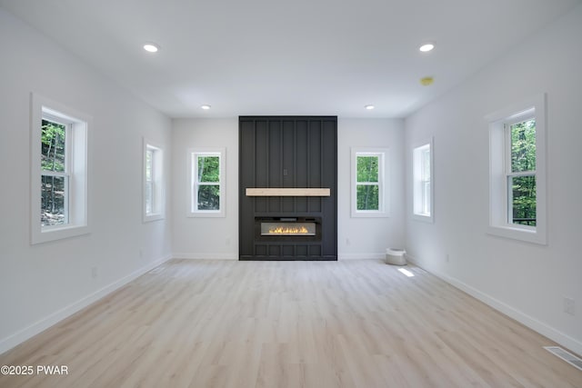 131 Song Mountain Dr, Tafton, PA 18464 - unfurnished living room featuring healthy amount of natural light, wood finished floors, a large fireplace, and recessed lighting