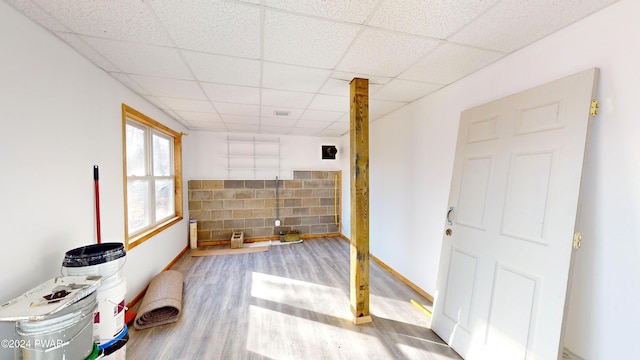 interior space with hardwood / wood-style floors and a drop ceiling