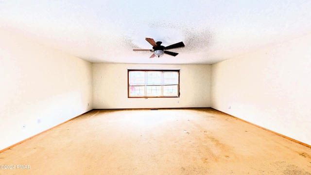 spare room with a textured ceiling and ceiling fan