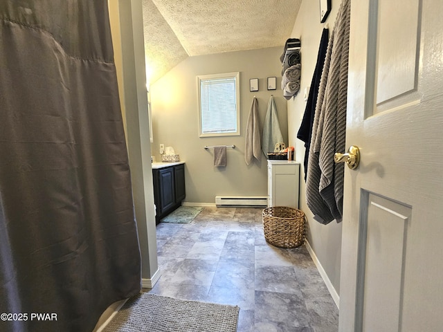 101 Summit Dr, Greentown, PA 18426 - full bathroom with a baseboard radiator, vanity, a textured ceiling, lofted ceiling, and stone finish flooring