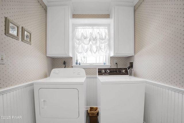 washroom featuring a wainscoted wall, separate washer and dryer, and wallpapered walls