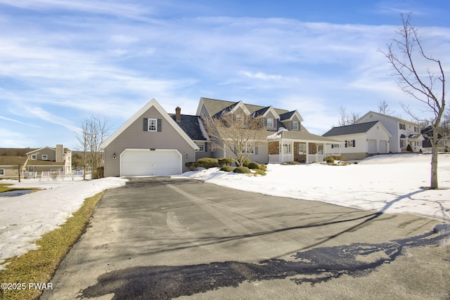 view of front of property with a garage, driveway, and a residential view