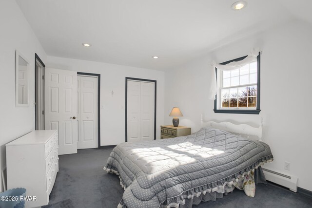 bedroom with recessed lighting, baseboard heating, two closets, and dark colored carpet