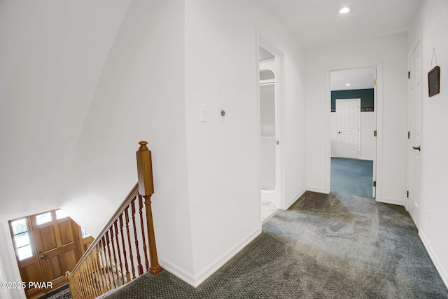 hall with carpet floors, recessed lighting, baseboards, and an upstairs landing