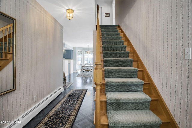 stairs with wallpapered walls, a baseboard heating unit, and tile patterned floors