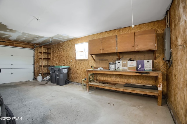 garage featuring electric panel and a workshop area