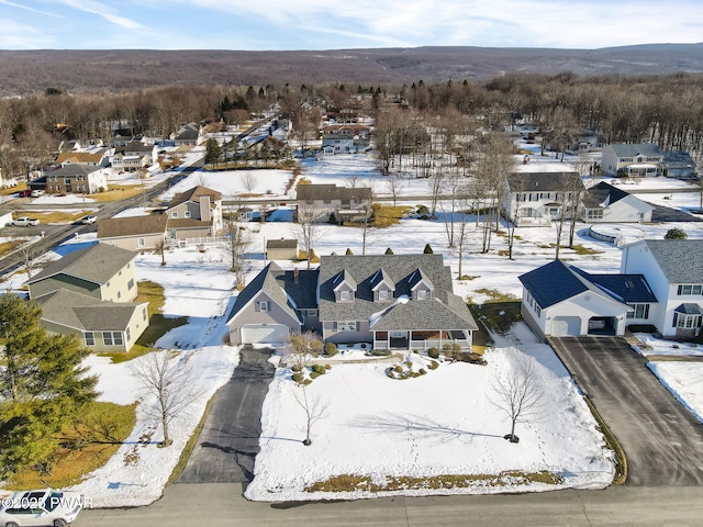 snowy aerial view featuring a residential view