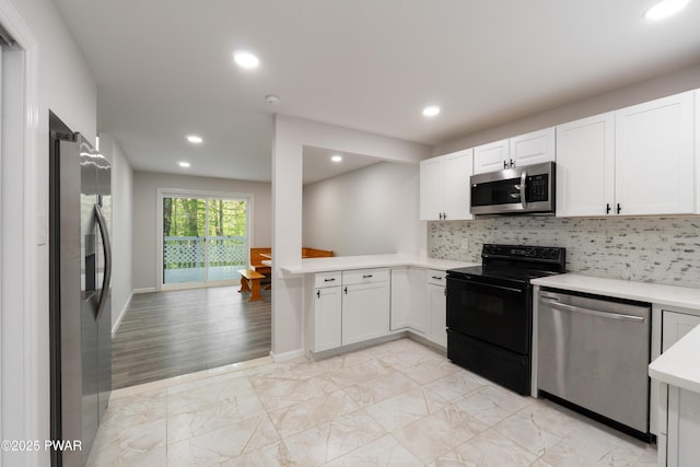 kitchen with stainless steel appliances, light countertops, recessed lighting, light marble finish flooring, and white cabinets