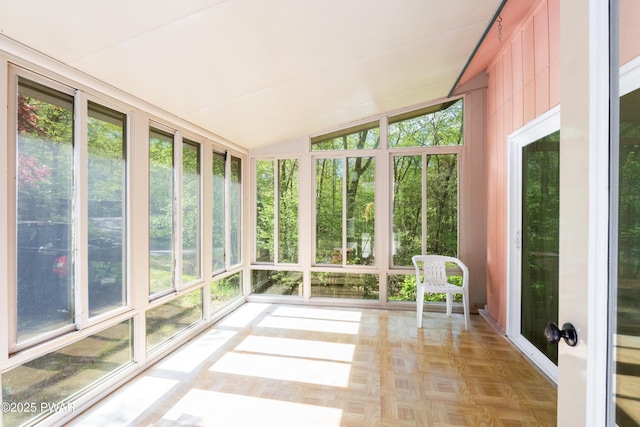 unfurnished sunroom with vaulted ceiling