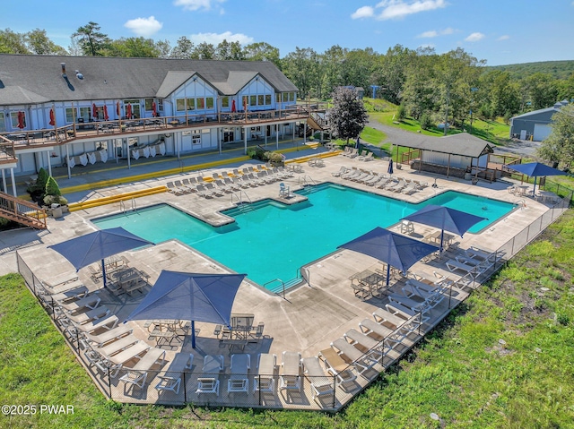 community pool featuring a yard and a patio area