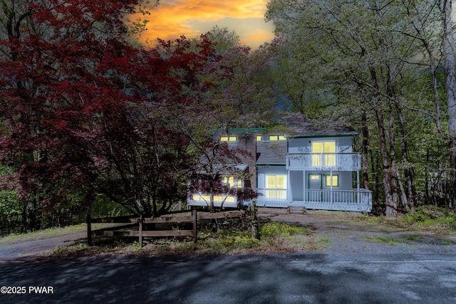 view of front of house with a porch and a balcony