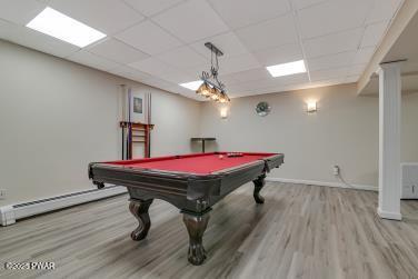 3043 Hemlock Rd, Stroudsburg, PA 18360 - playroom with wood finished floors, a baseboard heating unit, a drop ceiling, baseboards, and billiards
