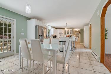 3043 Hemlock Rd, Stroudsburg, PA 18360 - dining area with a baseboard radiator and light tile patterned flooring
