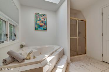 3043 Hemlock Rd, Stroudsburg, PA 18360 - full bath featuring a shower stall, a garden tub, a skylight, and tile patterned flooring
