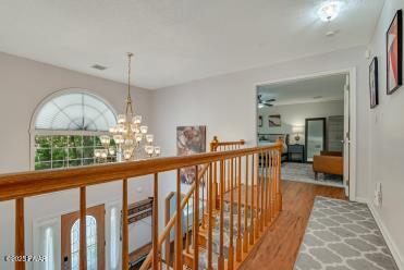 3043 Hemlock Rd, Stroudsburg, PA 18360 - corridor featuring an upstairs landing, wood finished floors, a chandelier, and baseboards