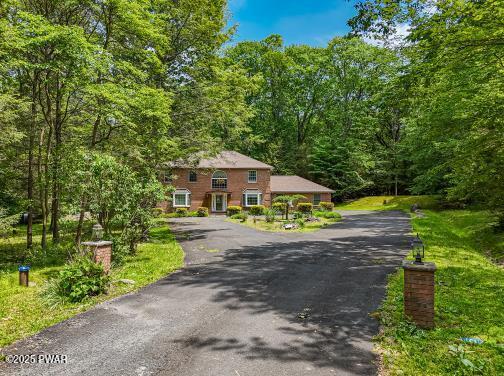 3043 Hemlock Rd, Stroudsburg, PA 18360 - view of front facade featuring asphalt driveway and a wooded view