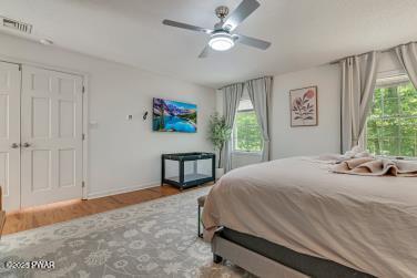 3043 Hemlock Rd, Stroudsburg, PA 18360 - bedroom featuring ceiling fan, wood finished floors, and baseboards