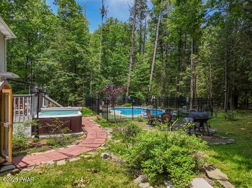 3043 Hemlock Rd, Stroudsburg, PA 18360 - view of yard with a hot tub and a forest view