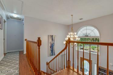 3043 Hemlock Rd, Stroudsburg, PA 18360 - hall featuring an upstairs landing, attic access, wood finished floors, and a chandelier