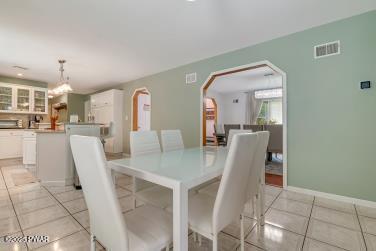 3043 Hemlock Rd, Stroudsburg, PA 18360 - dining area featuring arched walkways, light tile patterned floors, and baseboards