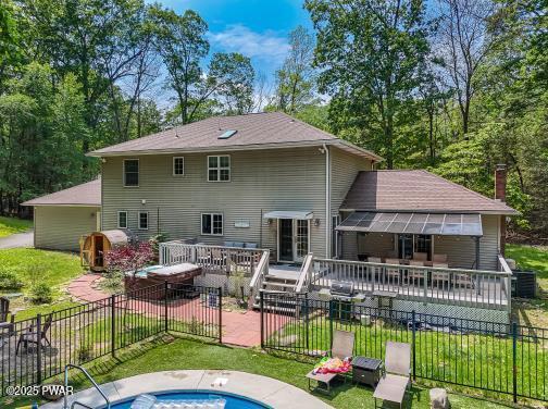 3043 Hemlock Rd, Stroudsburg, PA 18360 - rear view of house featuring a deck, a patio area, a hot tub, and cooling unit