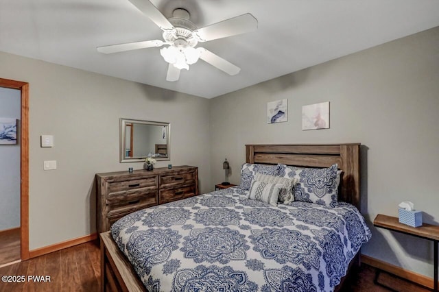 bedroom featuring ceiling fan, baseboards, and wood finished floors