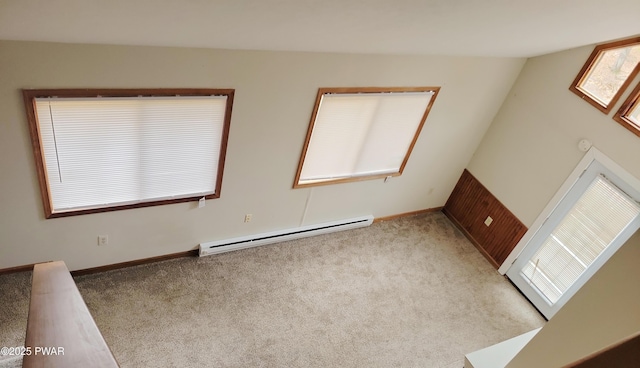 spare room with a baseboard radiator and light colored carpet