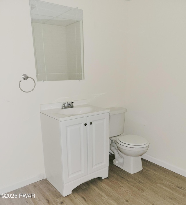 bathroom featuring vanity, toilet, and hardwood / wood-style floors