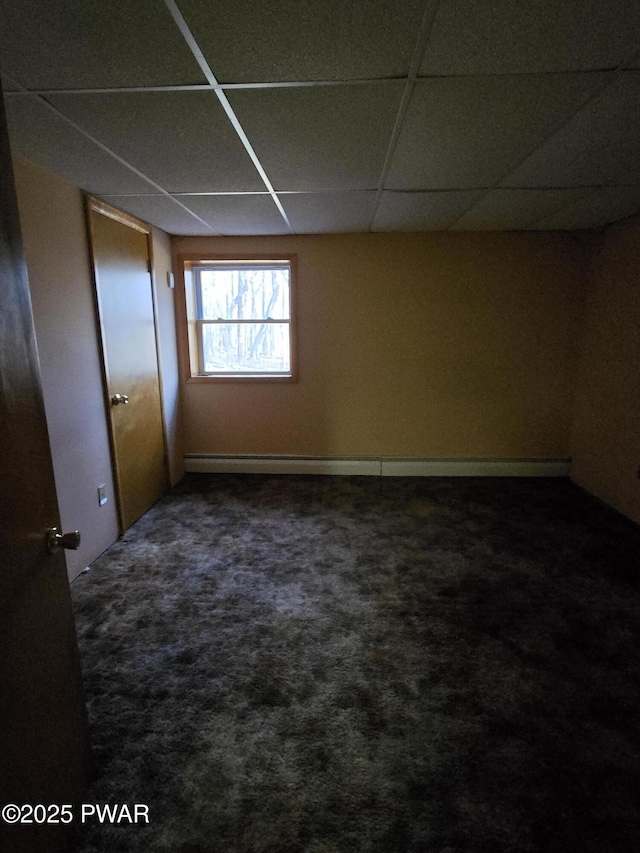 carpeted spare room featuring a paneled ceiling