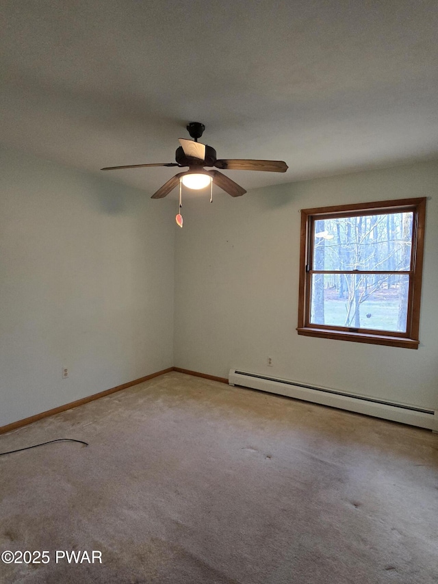 carpeted empty room with ceiling fan and a baseboard radiator