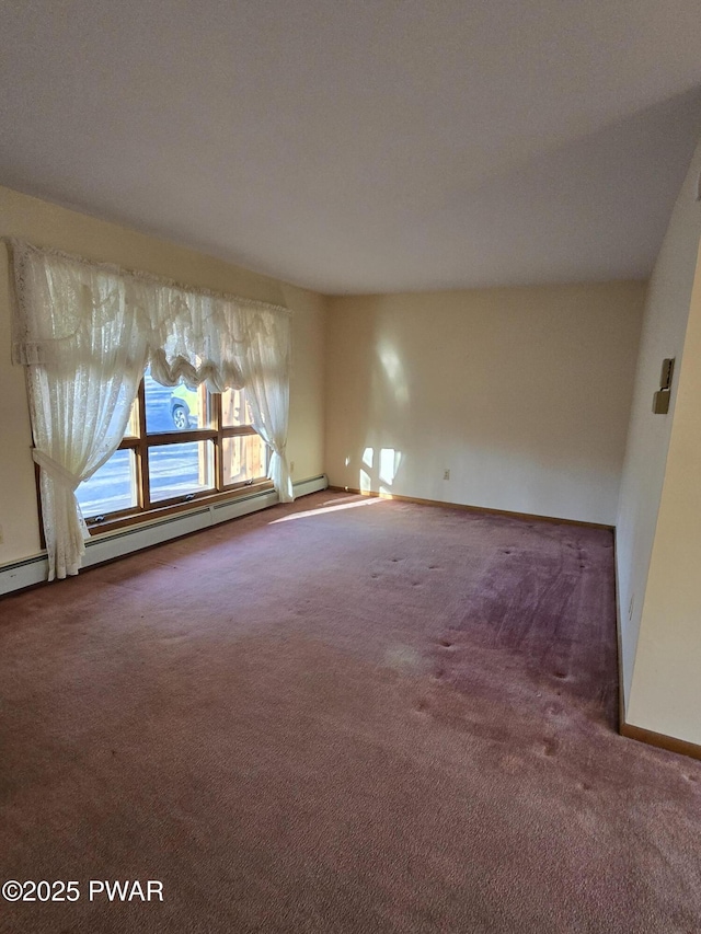 carpeted spare room featuring baseboard heating