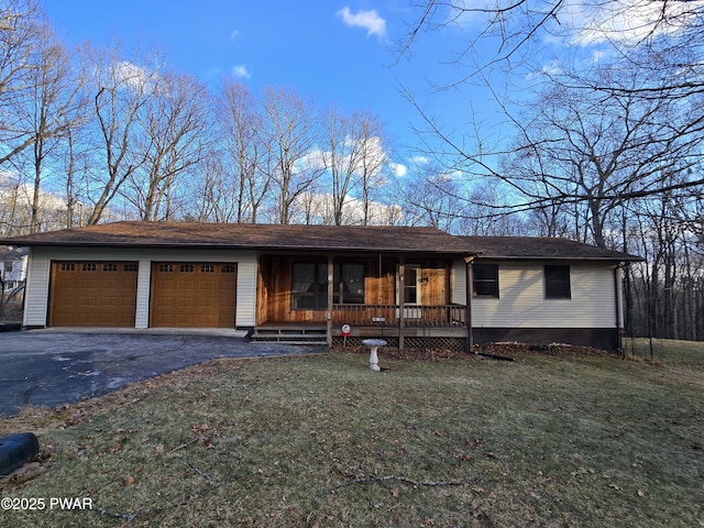 single story home featuring a front lawn, a porch, and a garage