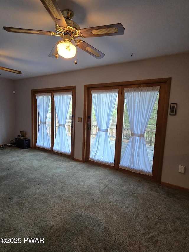 carpeted empty room featuring ceiling fan