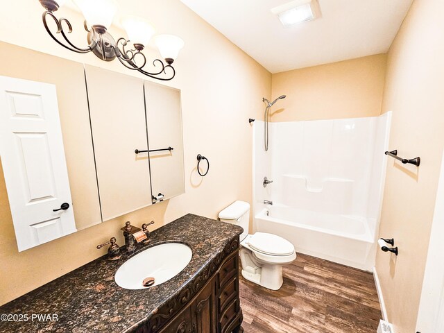 full bathroom featuring shower / tub combo, vanity, a baseboard heating unit, wood-type flooring, and toilet